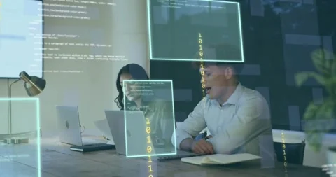 Tech development team typing on laptops at table, collaborating through Stock Footage 318141938