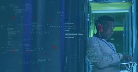 Tech diagnosing in data center aisle, with laptop, network cables and LED lit Stock Photos