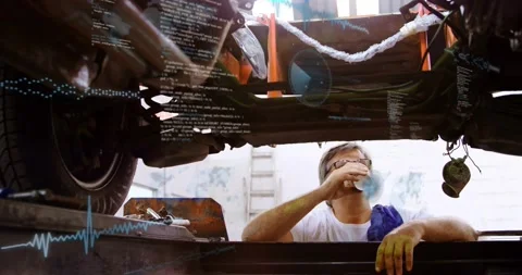 Tech emerging from lift taking sips and inspecting auto chassis with code Stock Footage 329910649