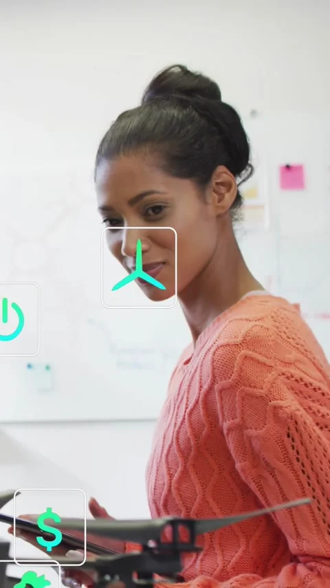 Tech engineer tapping tablet, with AR icons rising between her and drone and Stock Footage 334546724