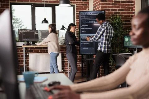 Tech enginners using binary code to script security system Stock Photos