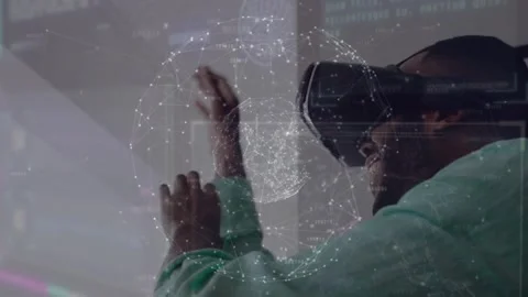 Tech expert wearing VR headset pinching holographic globe enabling interactive Stock Footage 319682411