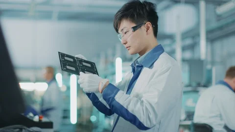 Tech Factory: Quality Control Engineer Checks Electronic Printed Circuit Board 動画素材 98199743