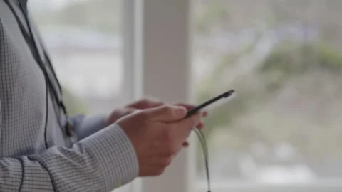 Tech Guys Hands Holding His Tablet with a Cord at Work Stock Footage 208798392
