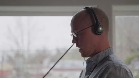 Tech Guys Working on His Headset and Tablet in His Office Stock Footage 208798196