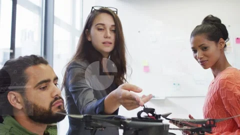Tech holding drone while lead moving in and pointing component, tablet tapping Stock Footage 333034970