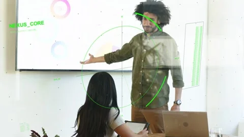 Tech lead raising and pointing display, causing green HUD overlaying screen and Stock Footage 333078409