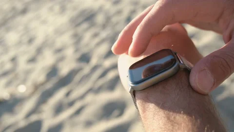 Tech man using smart watch to track beach training,hi tech healthy fit device Stock Footage 141727737