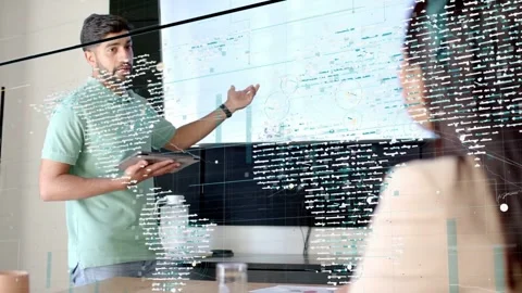 Tech meeting presenter pointing at display and tapping tablet showing overlay Stock Footage 337913038