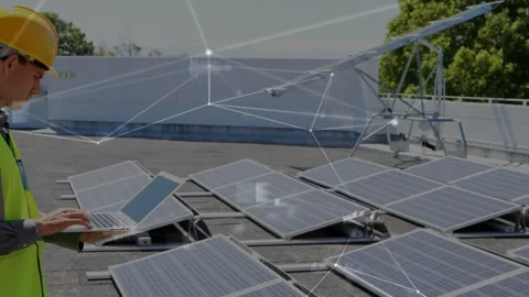 Tech opening laptop and typing by solar panels, monitoring as HUD links mapping Stock Footage 333494769