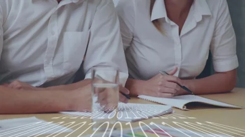 Tech overlay appearing, pair writing, pointing at chart, camera pulling back Stock Footage 332296465