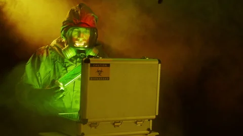 Tech places a biohazard sample in a case then looks around Video stock 40161505