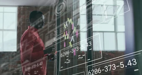 Tech planner selecting red marker and scanning notes, calling and scribbling on Stock Footage 315543712