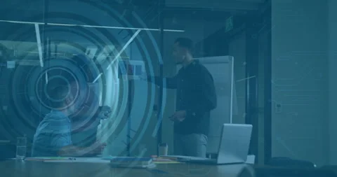 Tech presenter pointing flipchart and updating code rings upon colleague Stock Footage 310433579