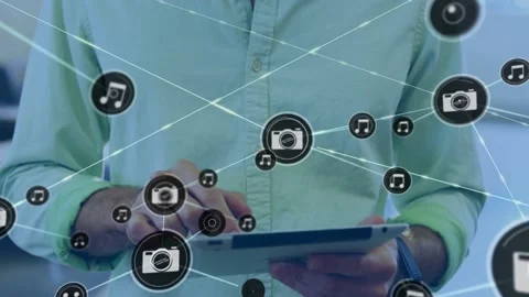 Tech pro tapping tablet generating camera music icons and lines layering over Stock Footage 329899748
