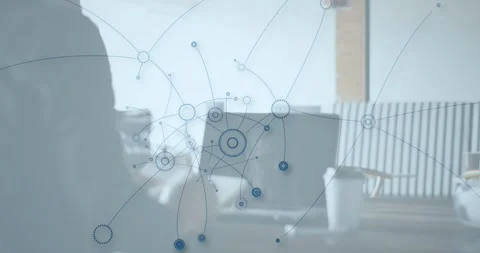 Tech pro tapping tablet at table and activating network nodes growing over Stock Footage 333904978