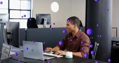 Tech pro typing celebrating win calling peer and pointing laptop as purple orbs Video stock 321781401