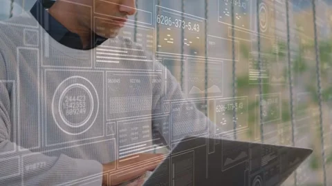 Tech professional typing on laptop and checking data, showing HUD with graphs Stock Footage 333999100
