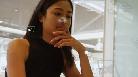 Tech professional typing on laptop and causing floating UI icons while pausing Stock Footage 334788848