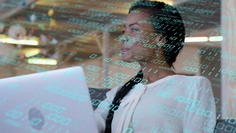 Tech professional typing on laptop in lounge, causing animated binary overlay Stock Footage 334373340