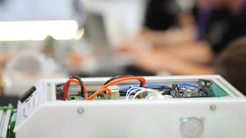 Tech prototype with open casing, visible internal wiring Stock Footage 345379520