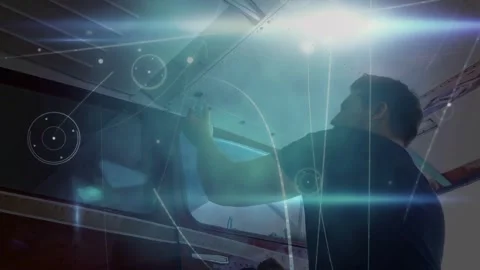 Tech reaching up using tool fixing aviation roof seam in bay causing blue HUD Video stock 331635458