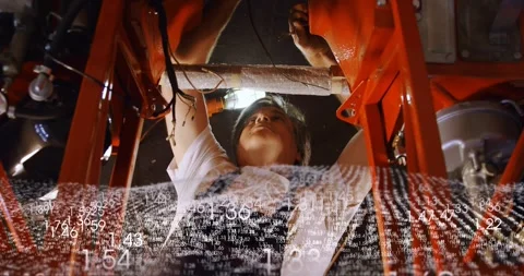 Tech reacting to data, inspecting and securing wiring beneath auto lift while Stock Footage 330159902