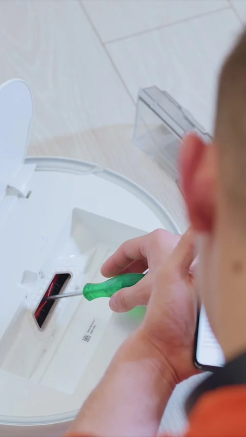 Tech Repair Using Screwdriver on Electronic Device with Smartphone Instructions Stock Footage 348037698