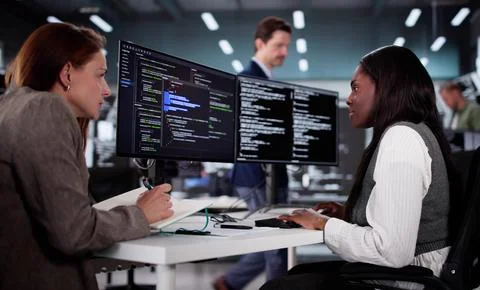 Tech-savvy African Engineer Developing Innovative Software With Diverse Team. Stockfoto's