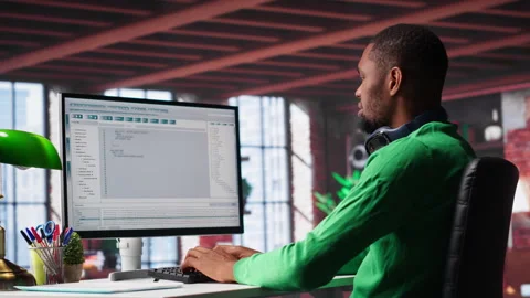 Tech savvy black engineer developing secure online program at home Stock Footage 307798148