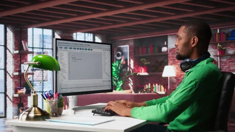 Tech savvy black engineer developing secure online program at home Stock Footage 307799339