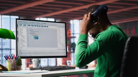 Tech savvy black engineer developing secure online program at home Stock Photos