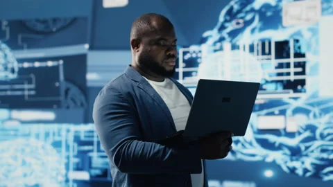Tech savvy black engineer working with AI brain data visualization Stock Footage 312478098