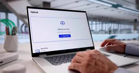 Tech-savvy Office Worker Uploading Data To Cloud Storage On Laptop. Stockfoto's