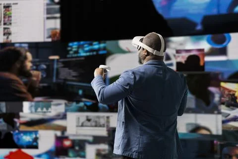 Tech savvy professional uses virtual reality glasses to see social media apps Stock Photos