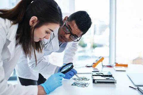 A tech savvy team to support any IT system. a young man and woman repairing Stock Photos