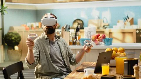 Tech-savvy worker uses virtual reality headset during home office workday Stock Photos