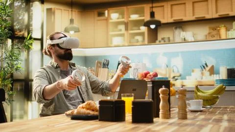 Tech-savvy worker with virtual reality headset enjoying modern telecommuting Stock Photos
