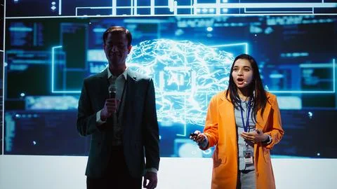 Tech specialists discussing during AI keynote summit presentation Stock Photos