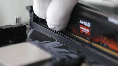 A tech specialist's hand in white gloves installs the RAM in the motherboard Stock Footage 195156171