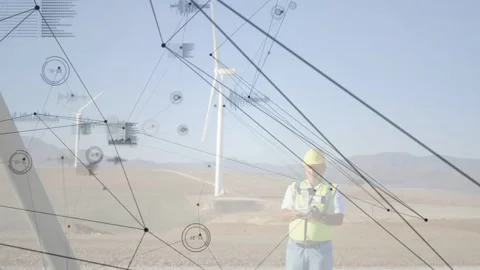 Tech standing at windfarm, HUD nodes animating, obscuring him, showing turbine Stock Footage 332591757