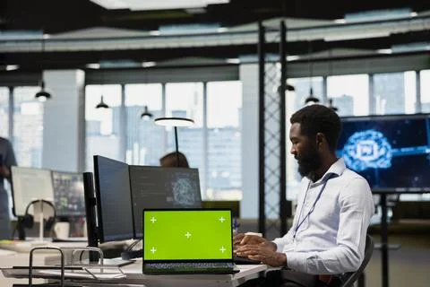 Tech startup office admin reviewing AI system metrics on isolated screen laptop Stock Photos