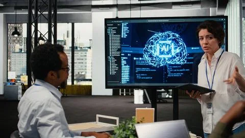 Tech startup office CTO doing presentation on machine learning to investors Stock Photos