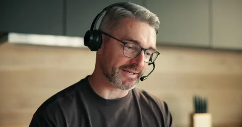 Tech support, agent and man with headset, home and talking with contact or help Stock Footage 321327196