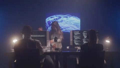 Tech Support Agents Working Together in a Dark Office Stock Footage 208766380