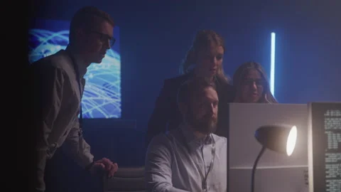 Tech Support Agents Working Together Around a Computer Stock Footage 208766602