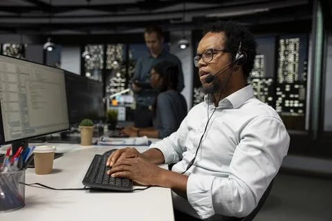 Tech support worker resolving technical faults, providing remote diagnostics Stock Photos