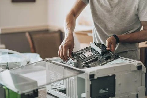 Tech Tactician: Meticulously assembling components, hands guide the central hub Stock Photos