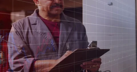 Tech tapping clipboard while camera pulling back showing grid and graph across Stock Footage 331570895