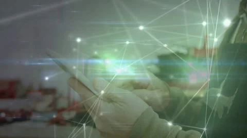 Tech tapping smartphone activating glowing node overlay checking data in shop as Stockbeeldmateriaal 332685756